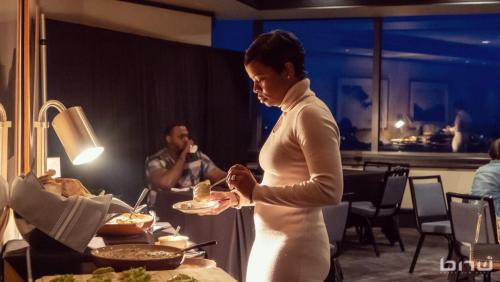 Black Eco Chamber 2.21.24-An attendee in the buffet line at the BECO X ELEVATE event.