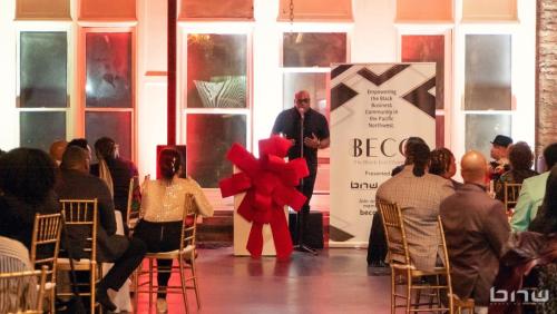 BECO Founder Shyan Selah speaks at the BECO 2024 Holiday Mixer Event at The Bindery in Tacoma, WA. Photo by Larry Dominico for Brave New World Enterprises.