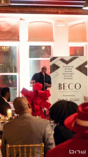 BECO Founder Shyan Selah speaks at the BECO 2024 Holiday Mixer Event at The Bindery in Tacoma, WA. Photo by Larry Dominico for Brave New World Enterprises.